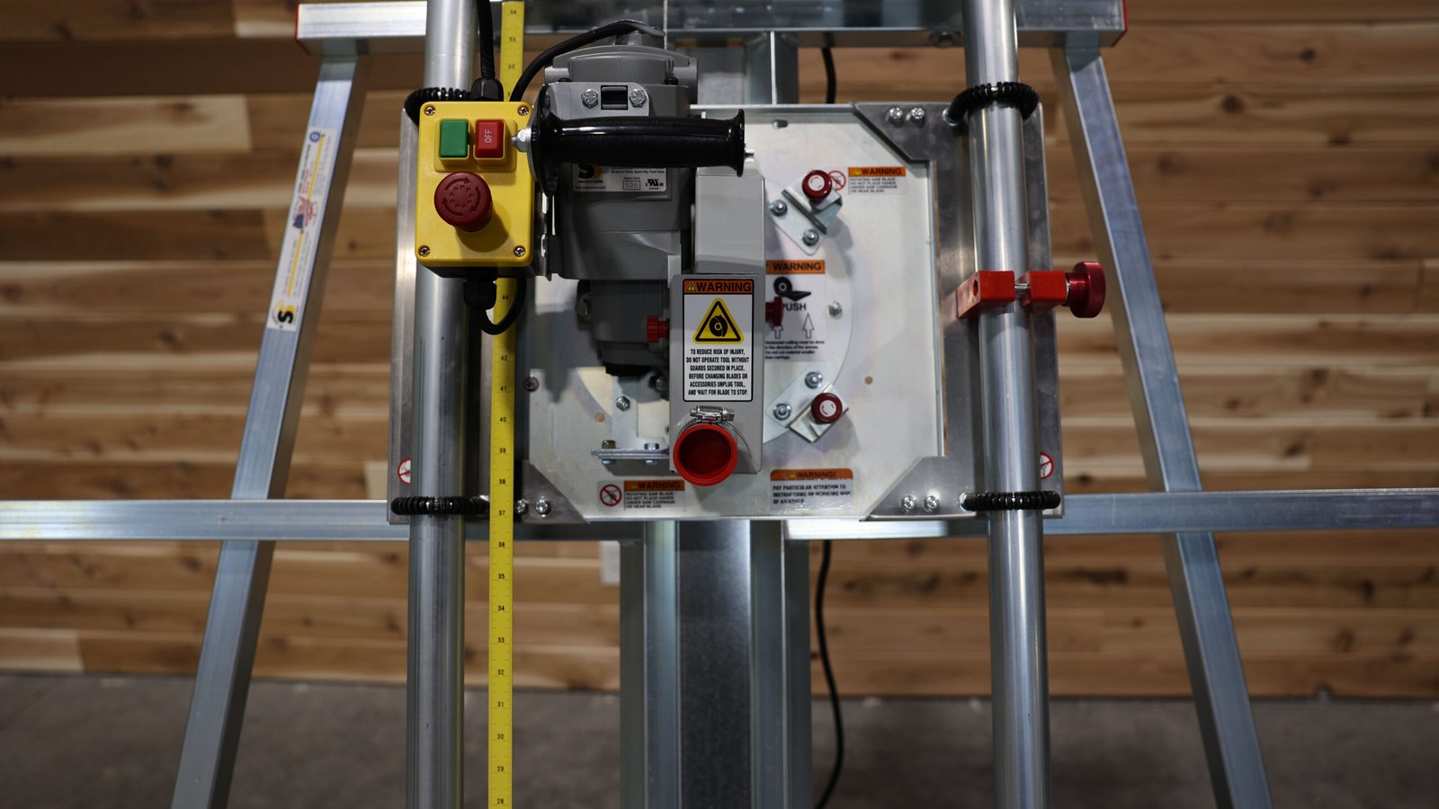 Close-up of the Safety Speed panel saw carriage with its motor, guard, lock knob and stop button on the track